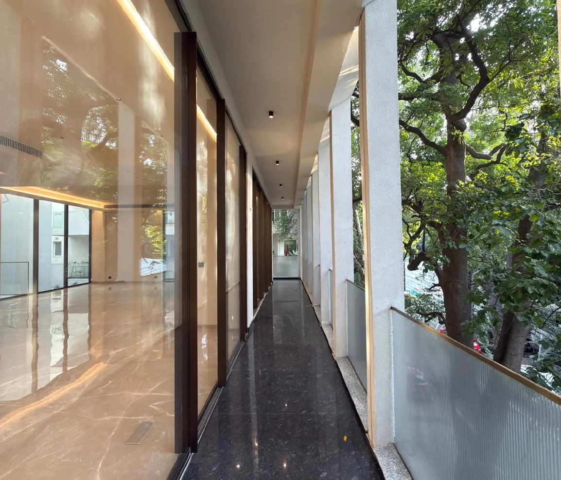 A long corridor of glass and marble beside the trees
