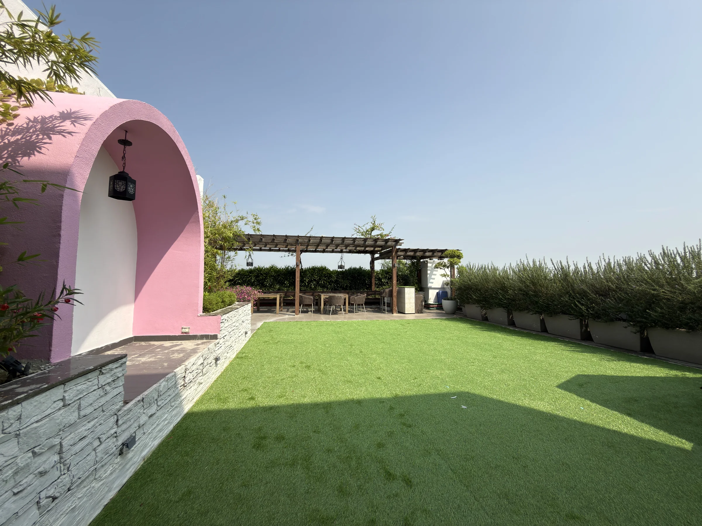 The terrace: a lawn, and a pergola with seating