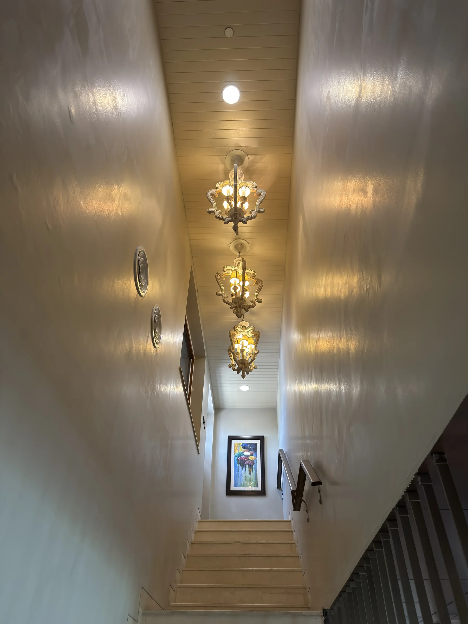 The staircase going up, with hanging lanterns
