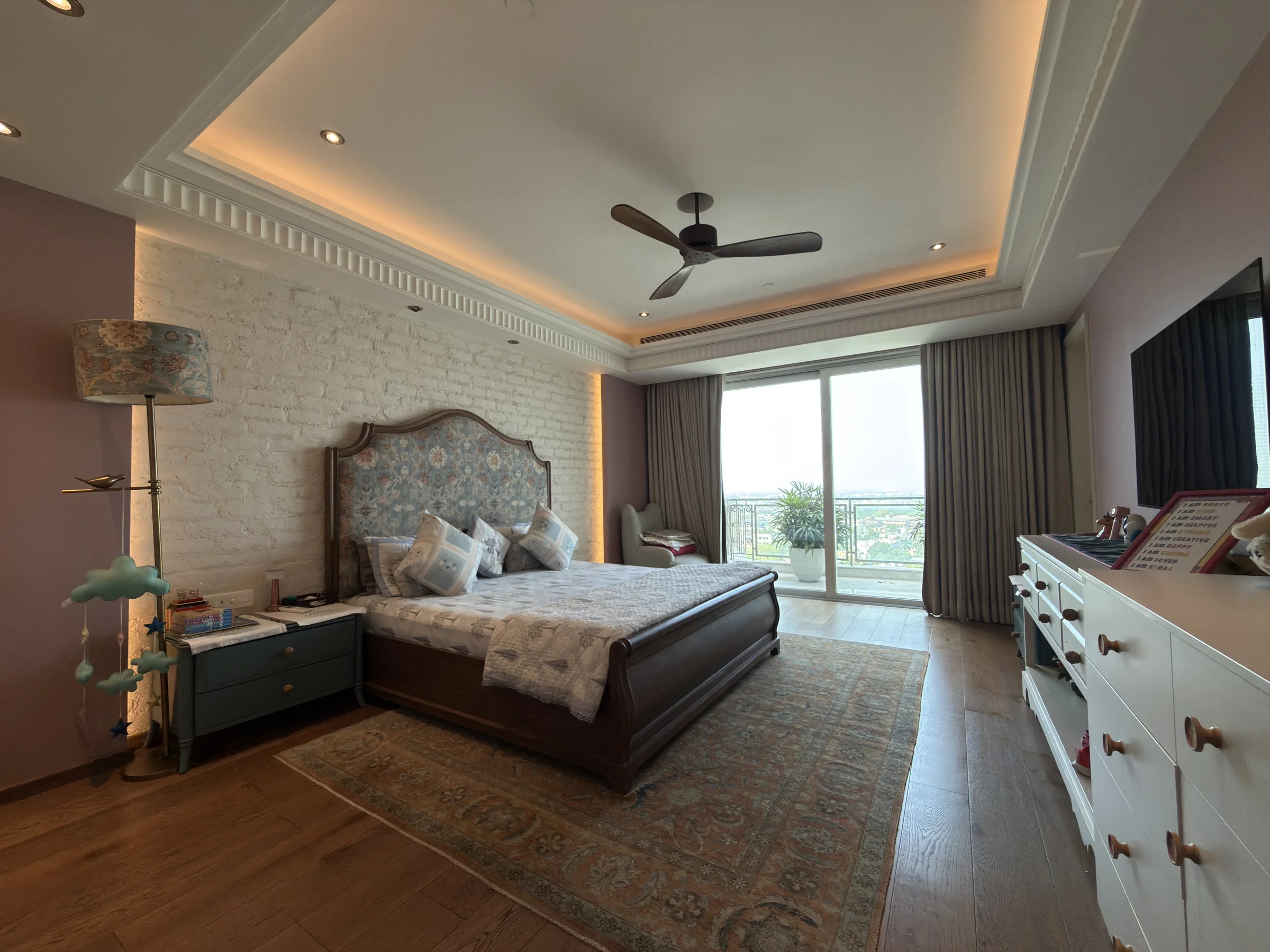A bedroom with glass doors to a balcony