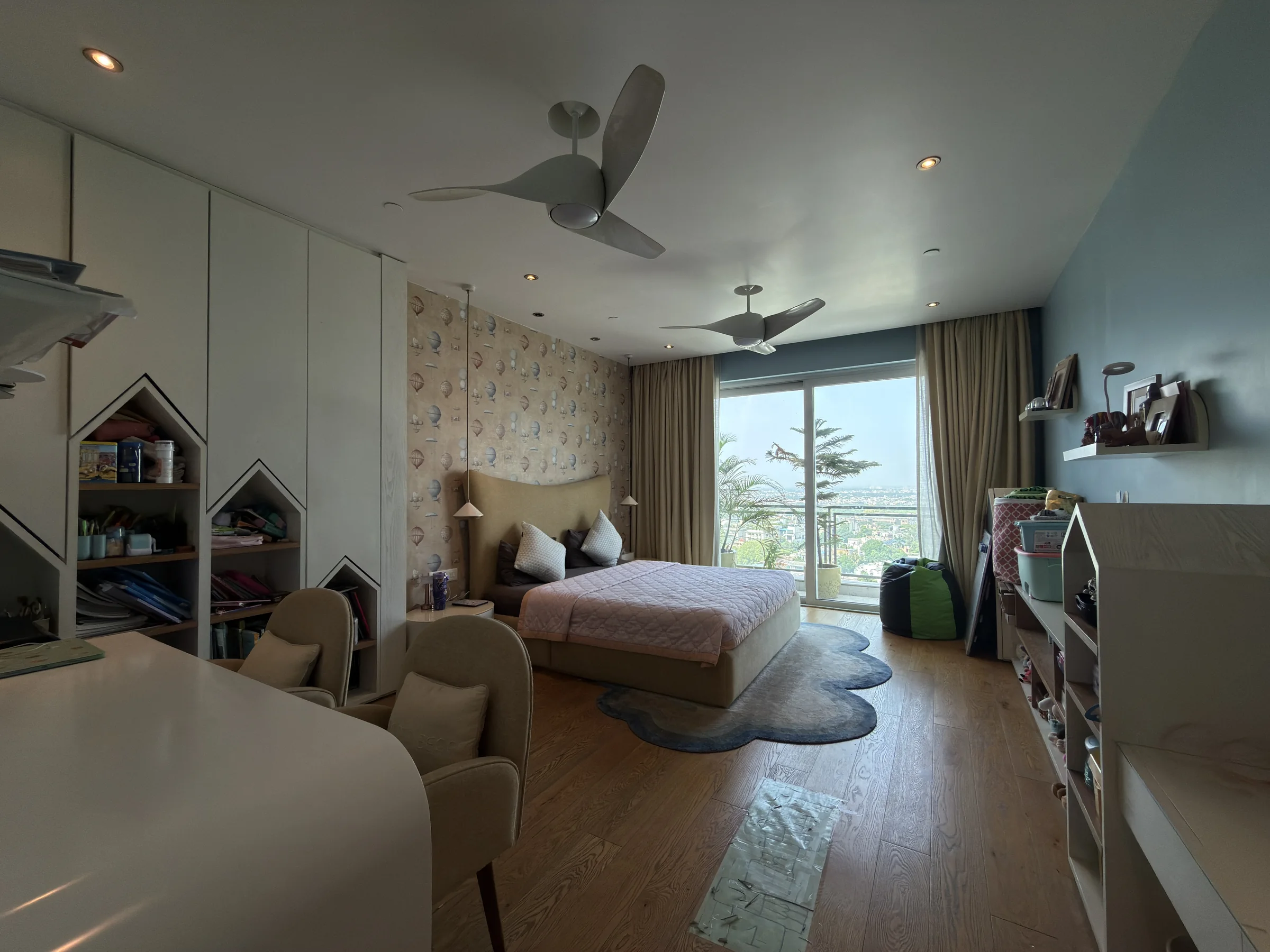 A bedroom with glass doors to a balcony