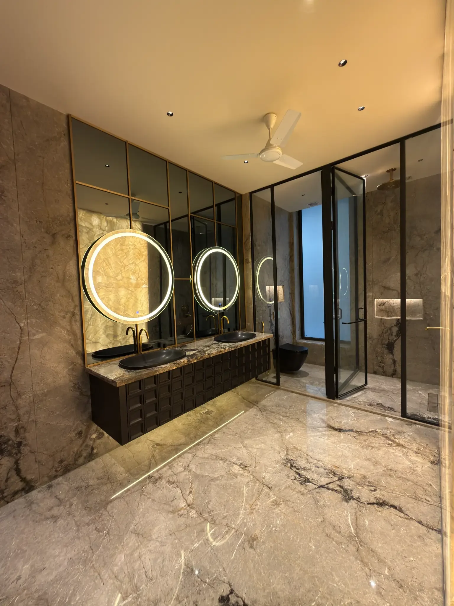 A bathroom, with two basins and a glass shower