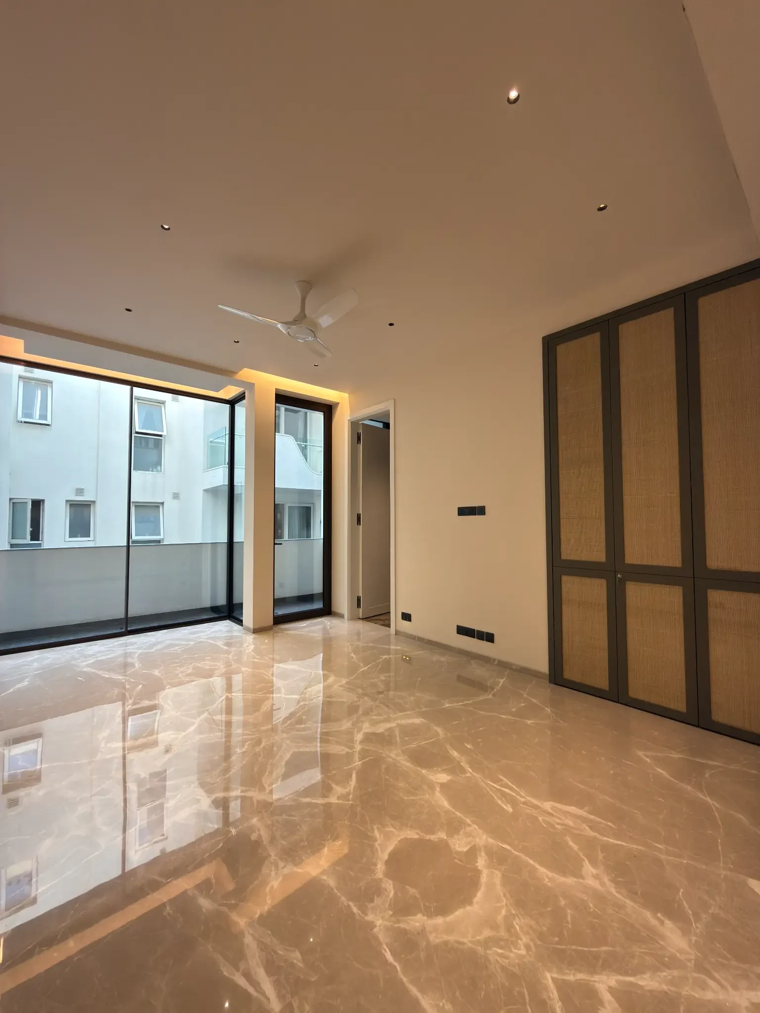 Another bedroom, with glass at the corner and built-in wardrobes