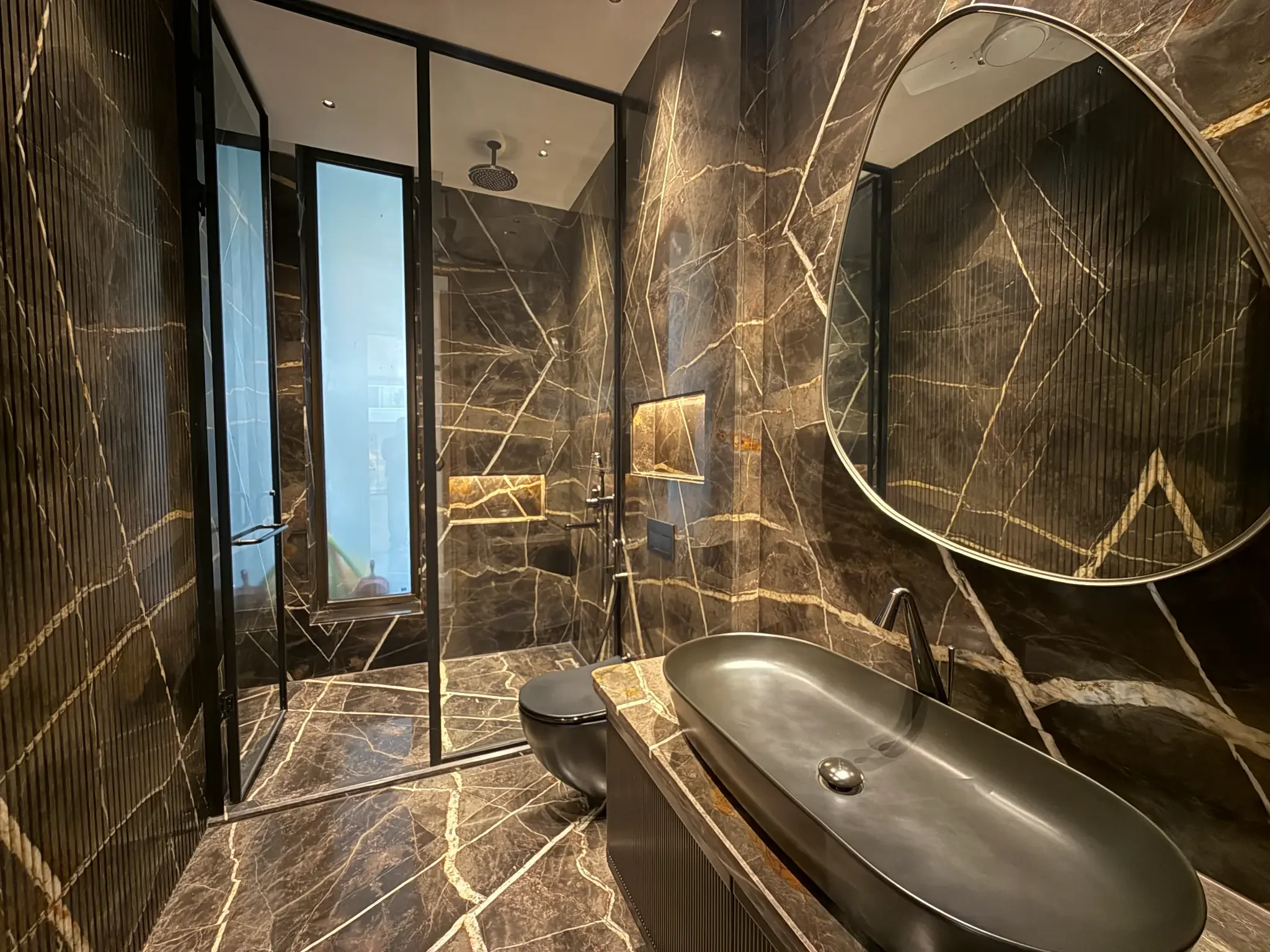 A third bathroom, in dark stone